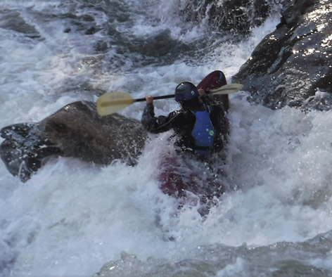 Kayaker getting surfed in class v+ Go Left and Die rapid in the Green River Narrows