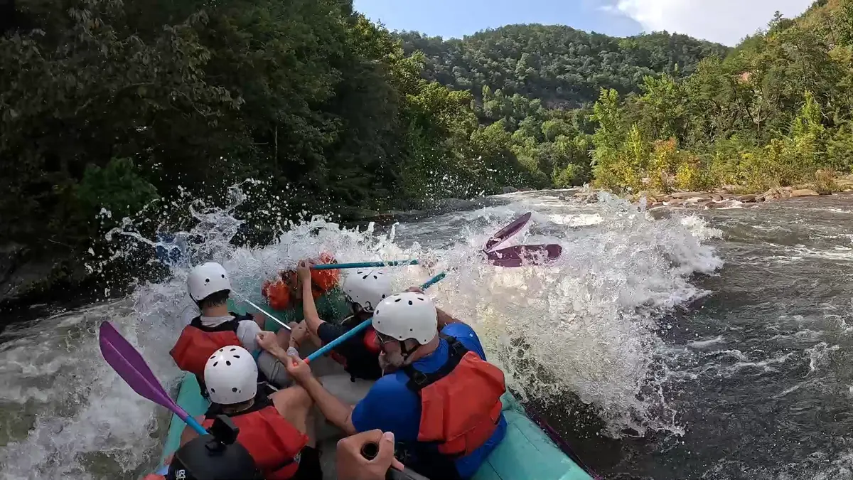 Raft punching Mike Tyson a breaking wave at Table Saw Rapid