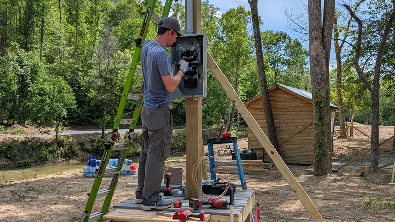 Constructing a custom power pole and deck to restore electrical service in Green River Cove after Hurricane Helene