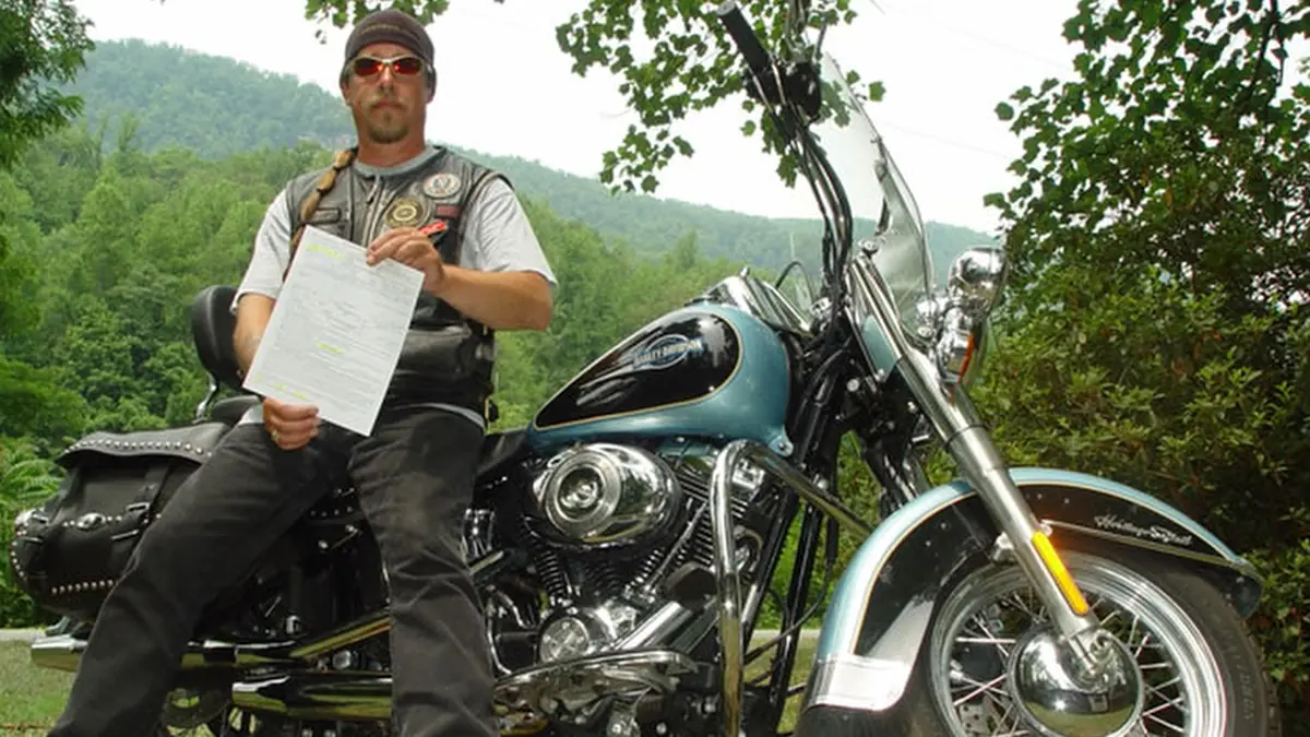 Fast Fred holding his second NC motorcycle helmet ticket in North Carolina