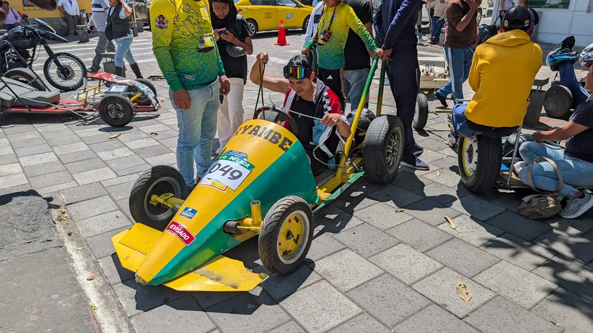 Wooden race cars being prepped in the pits for the Carrera de Coches de Madera in Baños, Ecuador