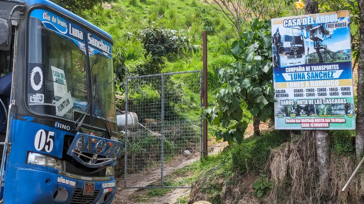 Bus stop and schedule sign for the route to Casa del Arbol treehouse in Baños, Ecuador