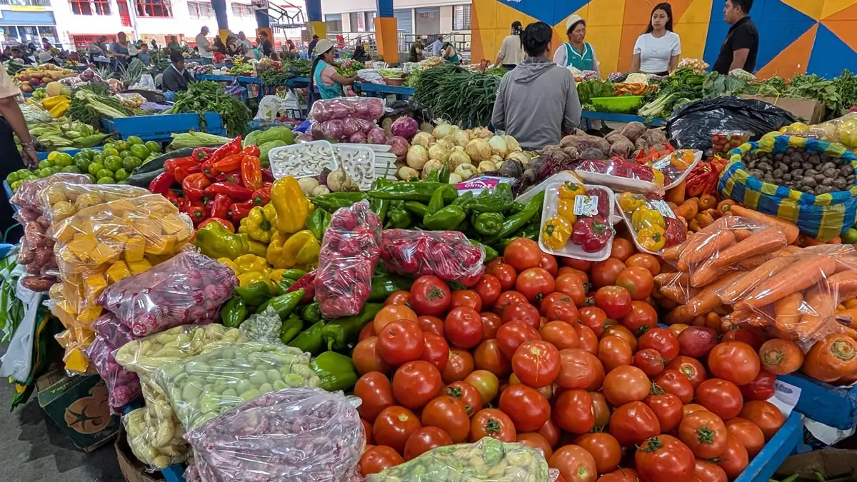 Abundant fresh fruits and vegetables on display at the local mercado in Baños de Agua Santa, Ecuador