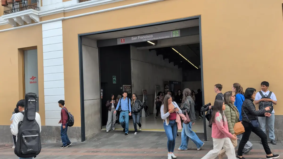 People walking out of the San Francisco Metro station exit onto the street in Quito, Ecuador