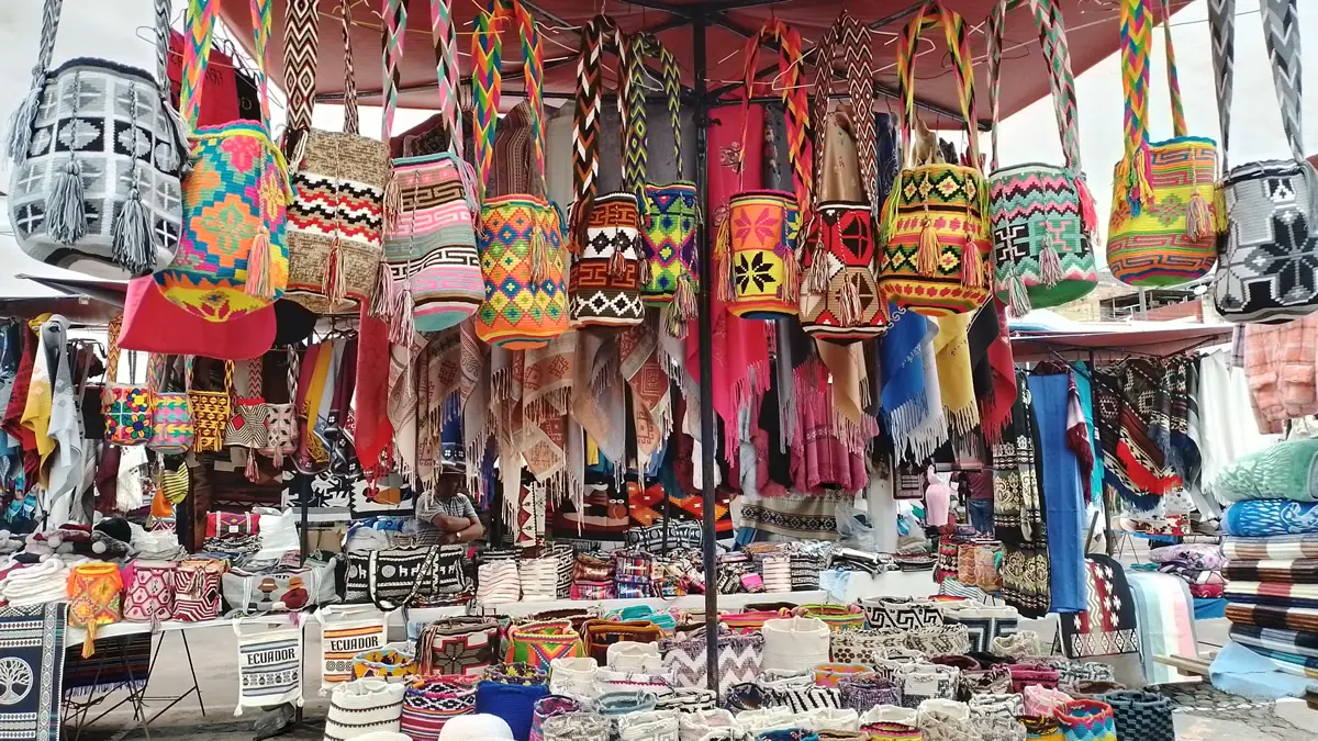 Vibrant hand-woven bags and textiles at Otavalo market