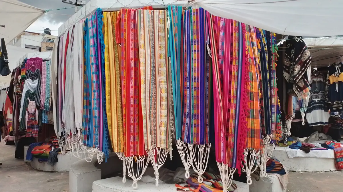 Hand-woven textiles on display at Otavalo market