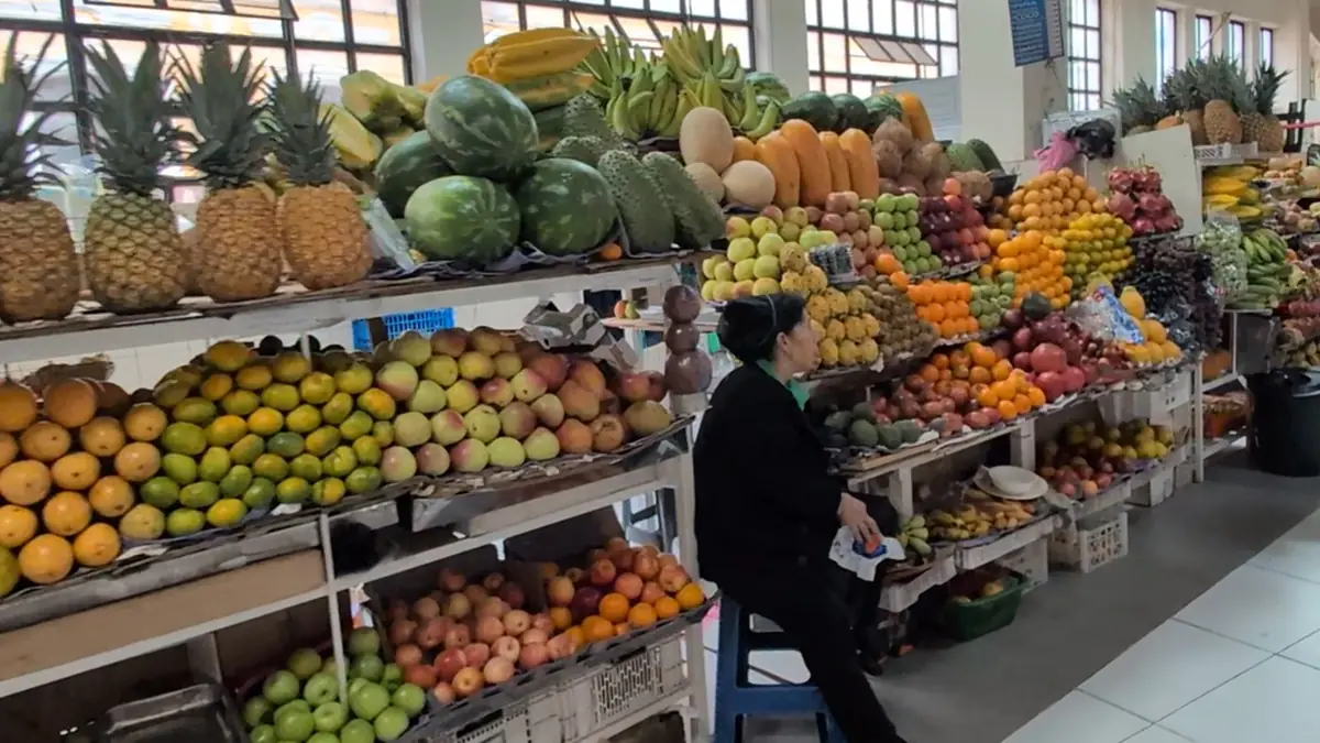Abundant stalls of fresh tropical and Andean fruits at the Mercado Central in Quito, Ecuador.