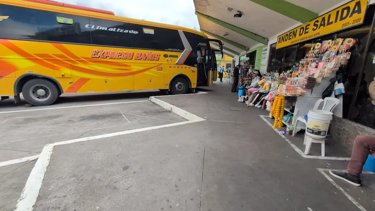 The bustling bus terminal in Baños de Agua Santa, Ecuador, a key transportation hub for travelers in the Andes.
