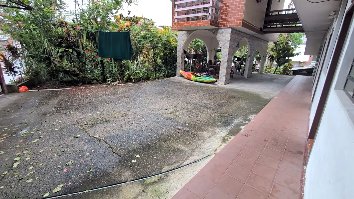 The shared kitchen and social common area of a budget hostel in Tena, Ecuador, a gathering space for Amazon travelers.