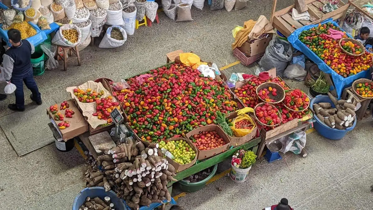 Bountiful fresh produce at a local Latin American mercado, illustrating the frugal travel strategy of shopping where the locals do.
