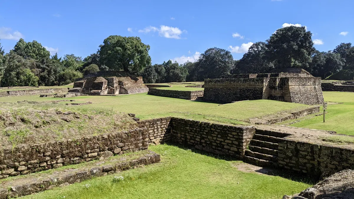 Ancient Mayan ball court positioned between two pyramids at the Iximche archaeological site in Guatemala
