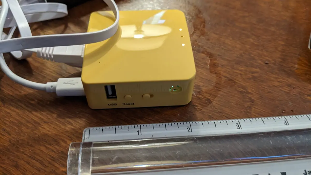 A portable travel router and hardware firewall device, essential for maintaining secure digital connectivity and protecting data while traveling.