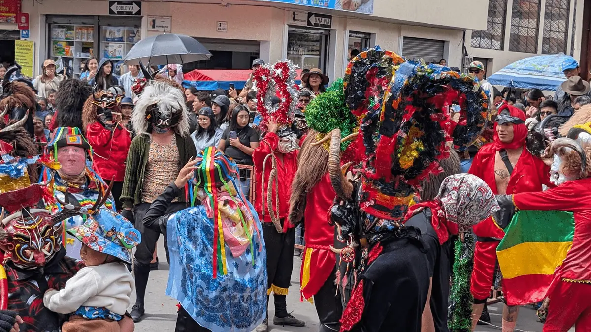 Vibrant costumed dancers and devil masks at the Diablada Pillareña festival in Píllaro, Ecuador