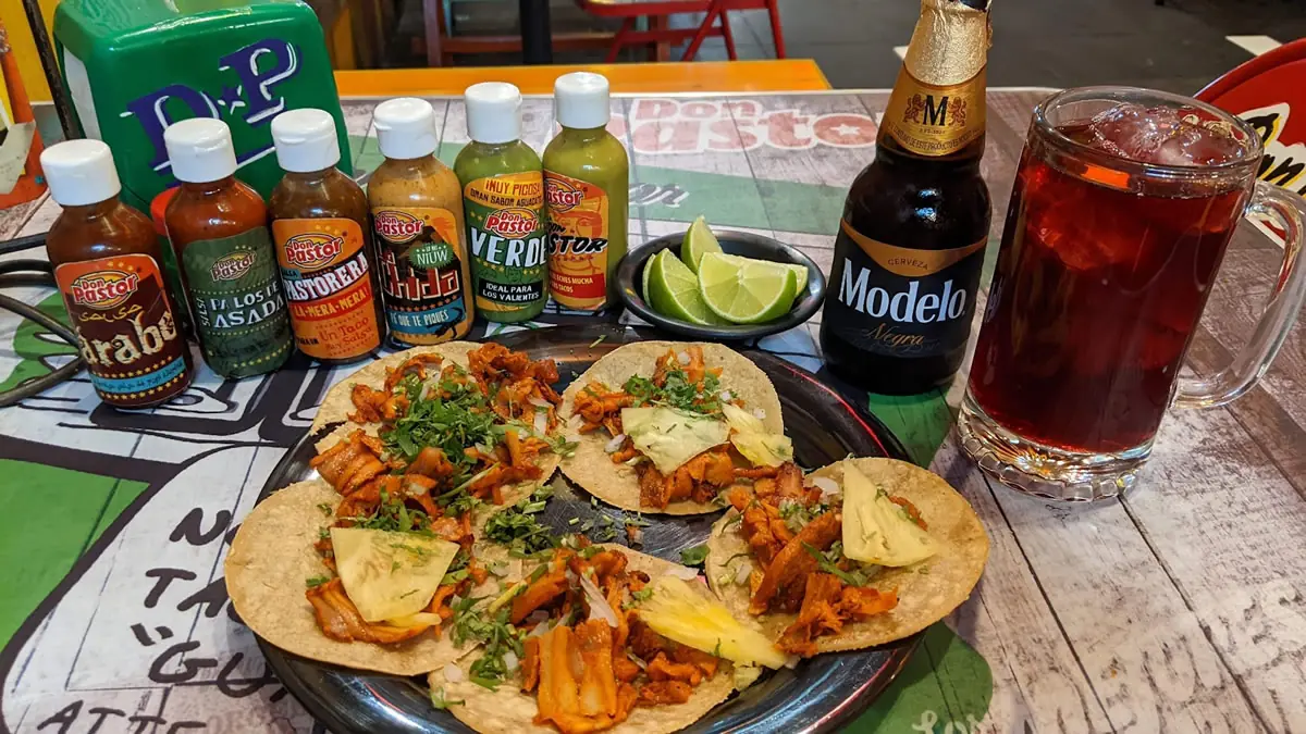 Tacos Al Pastor with salsa and Modelo beer in Puebla