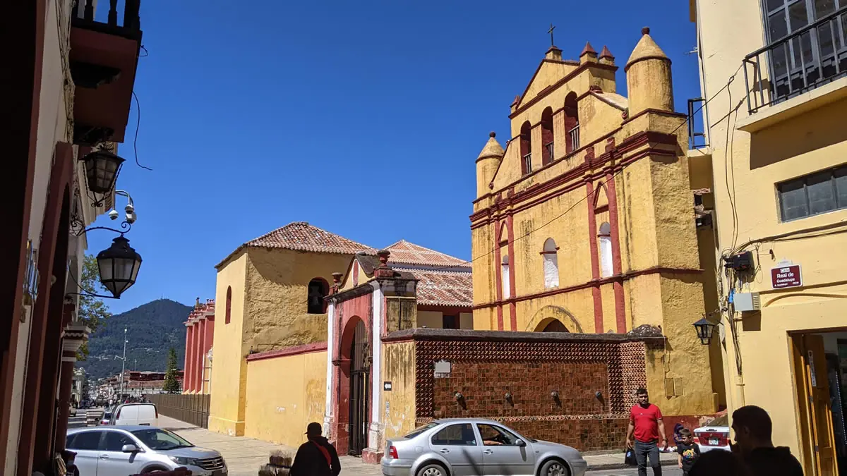 Historic yellow colonial church in San Cristóbal de las Casas, Mexico