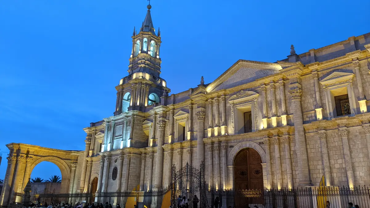 The historic Basilica Cathedral of Arequipa illuminated at dusk in the Plaza de Armas, Peru