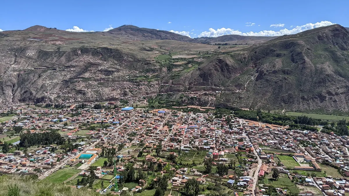 A scenic view of the Urubamba River and the surrounding Andean mountains in the Sacred Valley of Peru.
