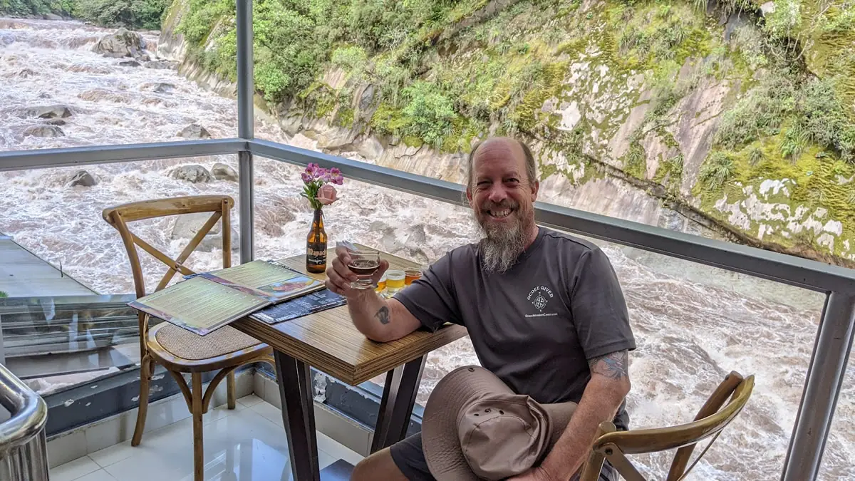 Fast Fred sampling local craft beer beside the raging Rio Urubamba in Aguas Calientes, Peru.